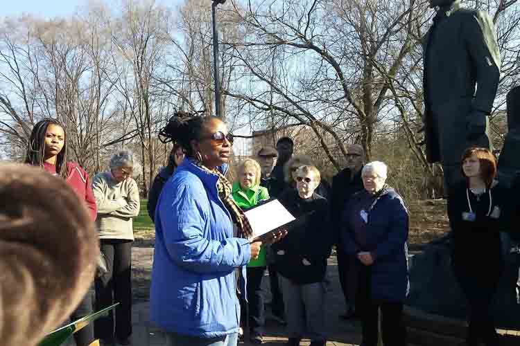 Denise Miller sharing a poem at the Underground Railroad monument in Battle Creek.