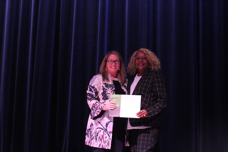 Kalamazoo Community Foundation President and CEO Carrie Pickett-Erway congratulates Charlene Taylor, who directs S.T.R.E.E.T., the winner of the foundation's Voting for a Cause initiative.