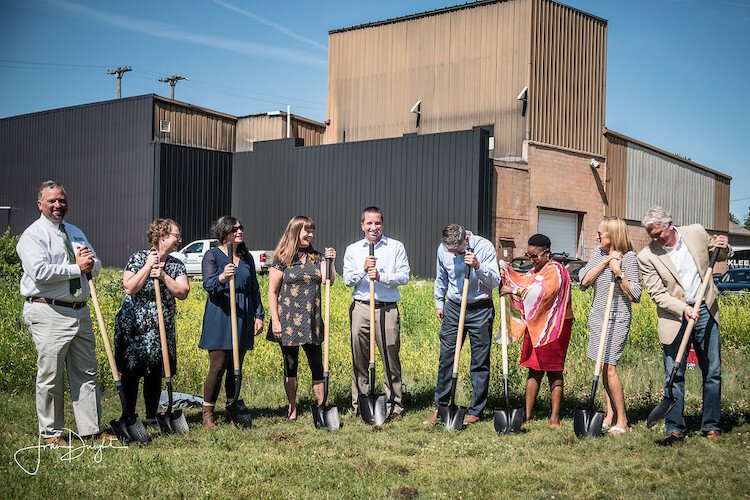 Tammy Taylor, left of center in print dress, participates in the June 2019 ground-breaking ceremony for The Creamery, a $14.7 million residential/commercial development in the Edison Neighborhood.