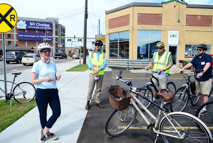 Rebekah Kik, Kalamazoo Community Planning and Development director, shows off the city's new protected bike lane on Kalamazoo Avenue.