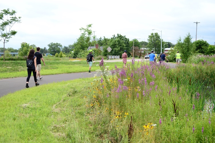 Training Wheels group, on foot, inspects new trail along Portage Creek.