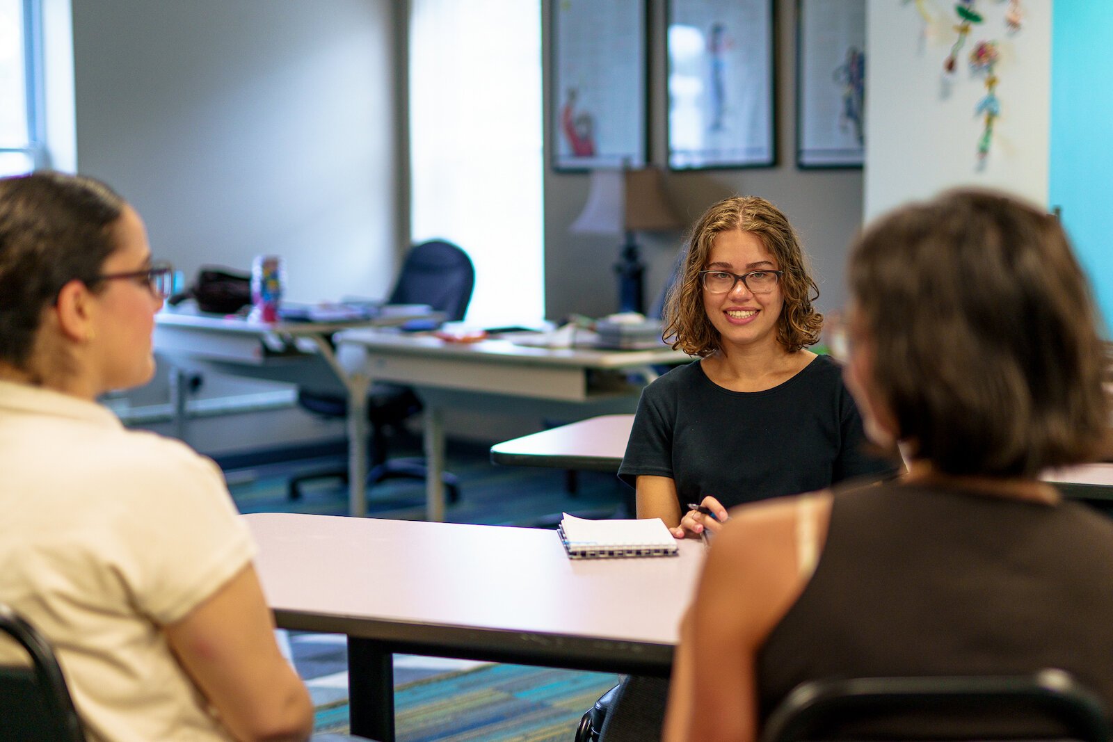 Cori Osterman (center), Haila Jiddou (left), Danielle DeVine (right) discuss the highlights of working as the first interns for Synergy Health Center.