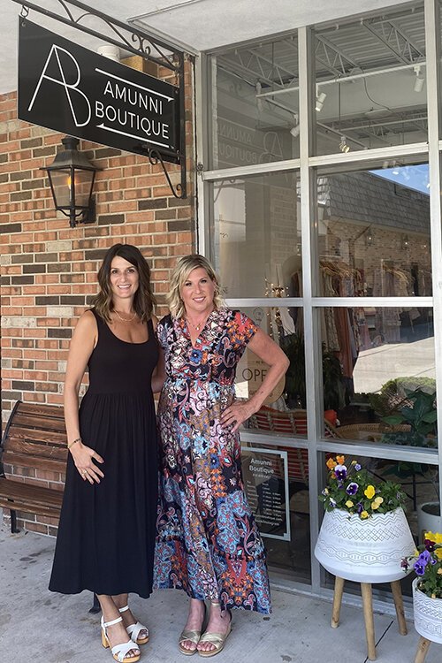 Amunni Boutique owner Ann Marie Oldford (left) and her friend Heather Benson, an MS advocate, pose for a photo outside Oldford's establishment in downtown St. Clair.