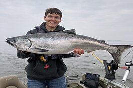 Nate Perry, owner of Michigan Honey Hole Fishing holding a King Salmon.