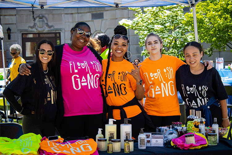 Owner of Flourish Hair Gallery (center) Naesa Richardson poses for a photo with her staff.