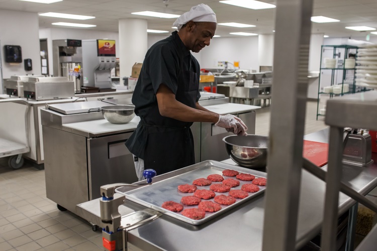 A chef prepares burgers ahead of Friday's grand opening