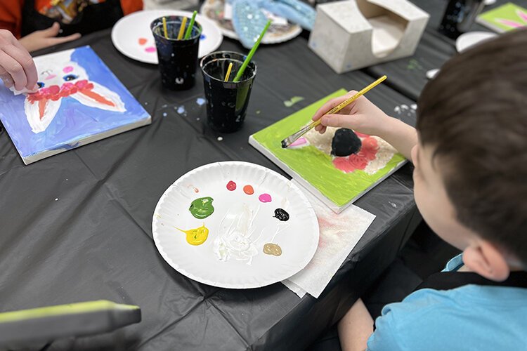 Children paint during an art class at The Painted Toad in Marine City.