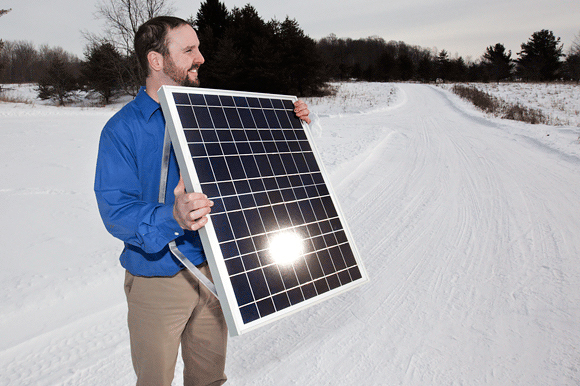 Dustin Denkins of Suburb Solar showcases a panel that helps produce energy