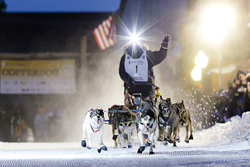 The first musher flys down the chute at the Copper Dog 150 Sled Dog Race, Calumet