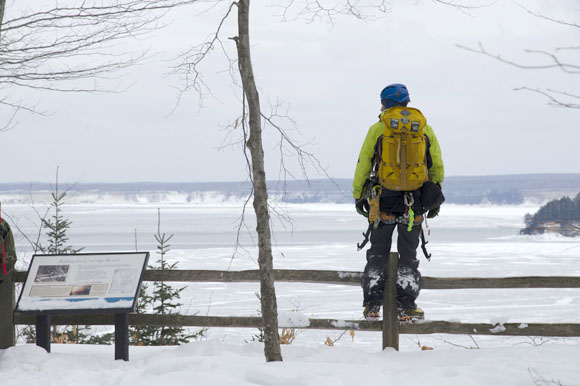 An ice climber takes in the views on Grand Island.