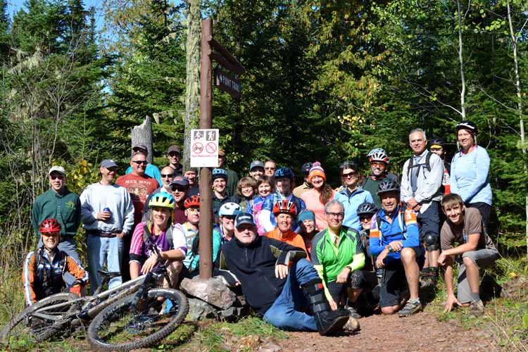 A group of mountain bikers and others gathered at High Rock Bay to celebrate the opening of a new section of the Keweenaw Point Trail.