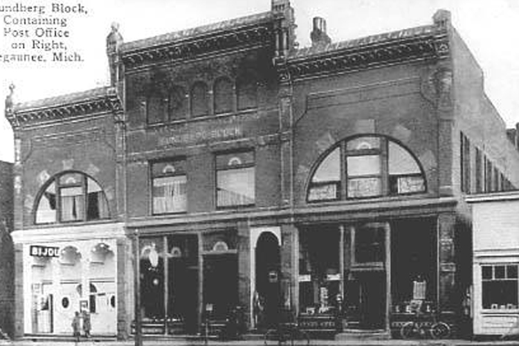 A historic postcard showing the Sundberg Building.