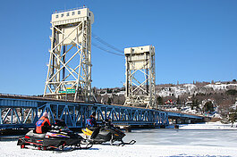 Snowmobilers at the Portage Lift Bridge, gateway to the Keweenaw I Shawn Malone