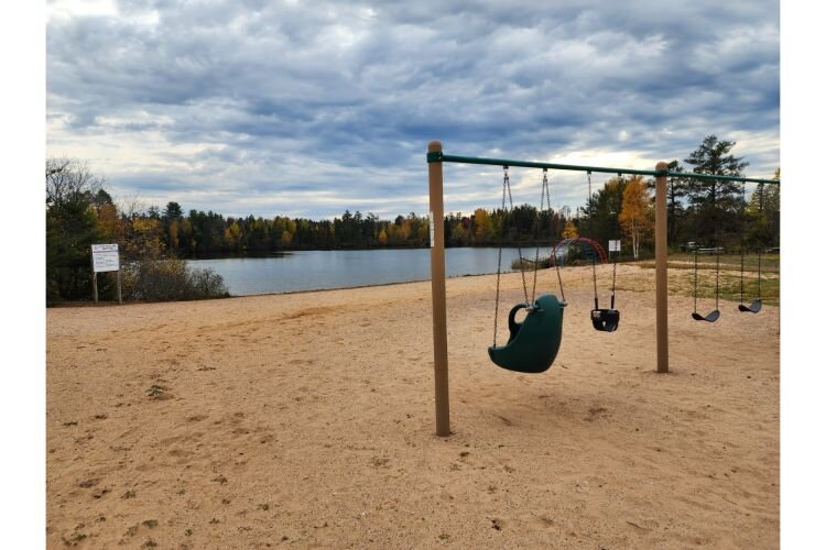 The North beach of Little Trout Lake is closest to many amenities like beach volleyball courts, playgrounds and pavilions in KI Sawyer.