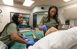 WCC nursing students work on a robot patient.