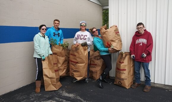 Students and staff from Bay City Central High School recently volunteered to clean up grounds around the CAN Council building.