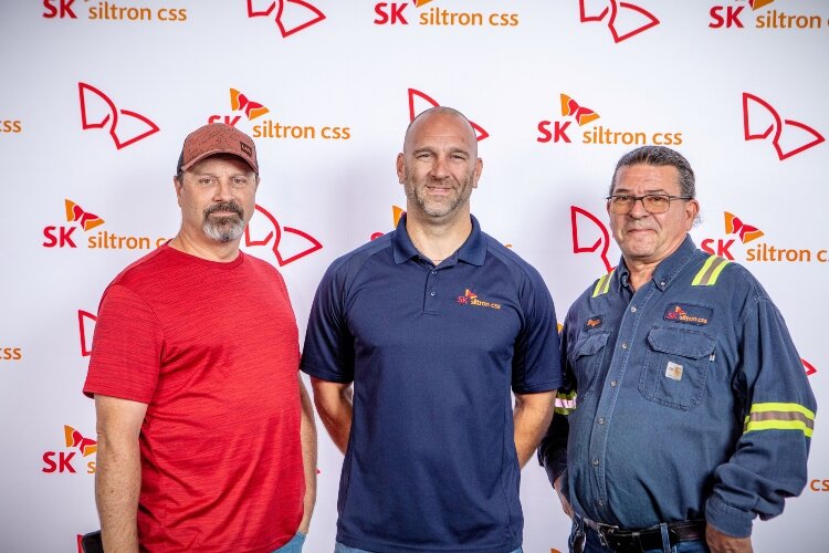 Bryan Draves, at right, says he's found the job of a lifetime at SK Siltron CSS. Here, he poses with co-workers Earl Lewis (left), a Production Engineer, and Dave Cronk (center), a Material Scheduler. 