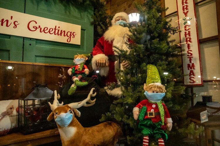 In the window of Little House, 924 N. Water St., Santa and his elves are donning masks to slow the spread of COVID-19 during the holidays.