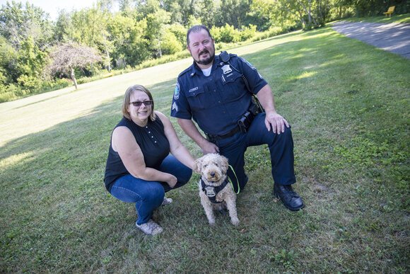 Pinconning City Manager Dawn Hoder and Police Capt. Terry Spencer, take their furry friend Blaze to a field that will become a dog park.