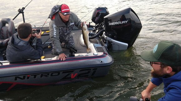 Mark Gwizdala of Kawkawlin catches walleye on the Saginaw Bay during the filming of a documentary about efforts to restore a reef and improve fish habitat.