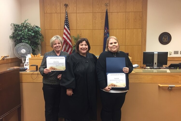 Kimberly Prime, at left, a volunteer advocate for children, poses with Family Court Judge Jan A. Miner during a swearing-in ceremony