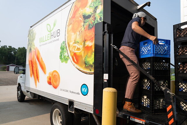 Kelly McHugh, logistics flex tech at ValleyHUB at Kalamazoo Valley Community College, loads local milk for delivery to Bronson and other customers in Kalamazoo.