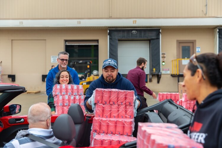 Volunteers from the United Way of Bay County as well as Michigan Sugar helped load sugar into each vehicle.