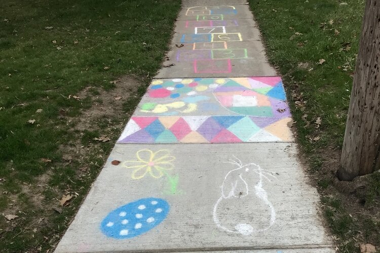 A hopscotch game, bunnies, and colorful patterns greet walkers in this Midland neighborhood.