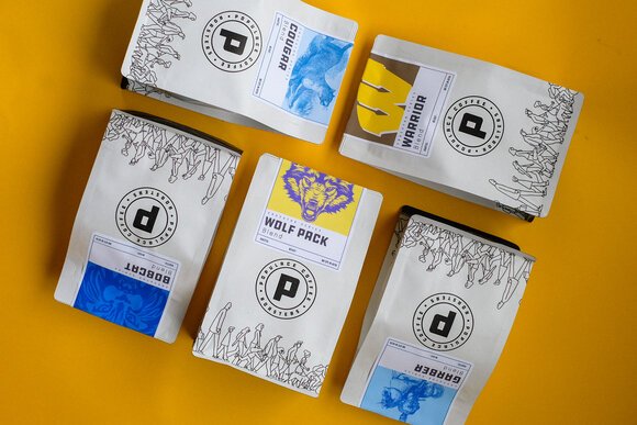 Populace Coffee had five special labels designed for their house blend coffee, each displaying the names and logos of local high schools.