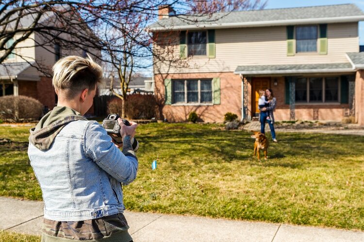 Photographer Ashley Brown stands 10 to 15 feet away from the people featured in her Porch Portraits Project.