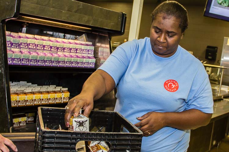 Michelle Austin helps prepare Michigan farm goods for students at Battle Creek Public Schools.