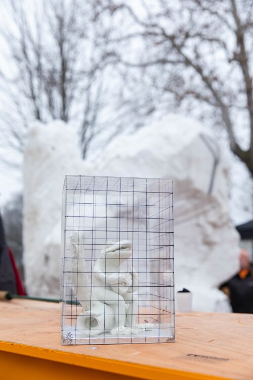 The team of Tom Gillman, Jacob Gillman, and Bryce Martin created a singing, guitar-playing frog from their block of snow.