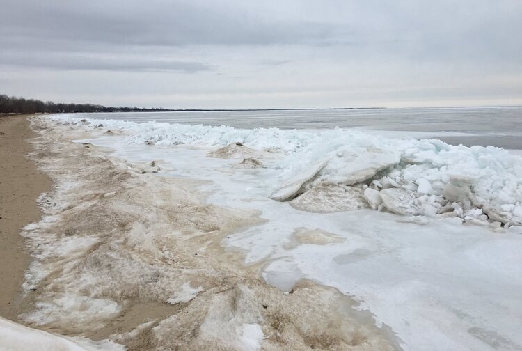 Sand and ice swirl together along the edges of the Saginaw Bay in the winter, creating a unique landscape at the Bay City State Park. The park offers winter activities for families including a special Feb. 15 event.