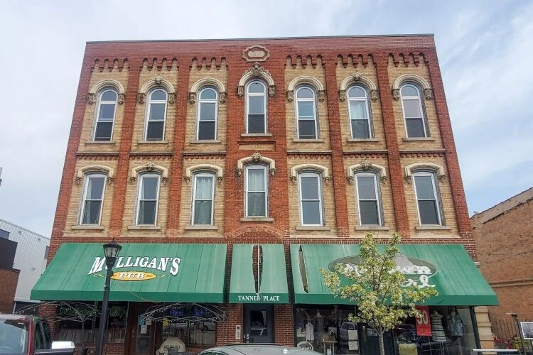 A faded green awning faced Center Avenue before the building's owner took advantage of a Facade Improvement Grant.