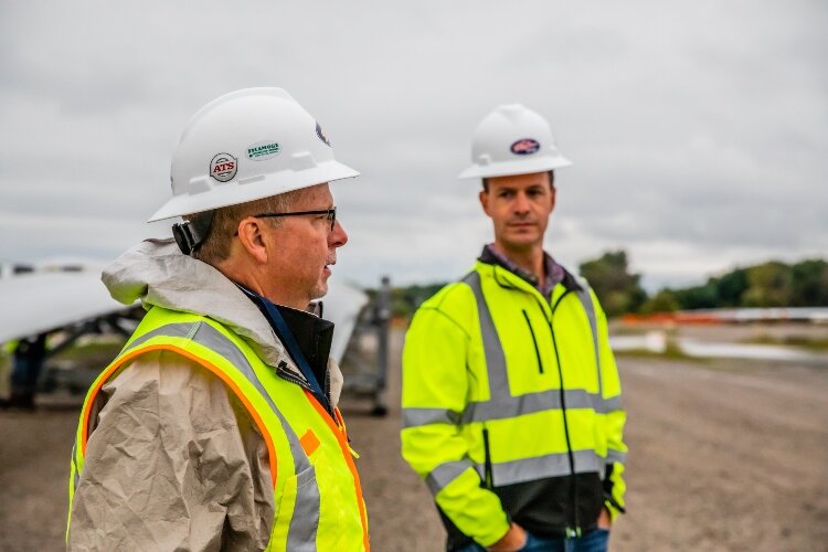Paul Strpko, sales manager for Fisher Companies, at right, talks to Bay Aggregate Manager Kevin Cotter at the Fisher Port Terminals.