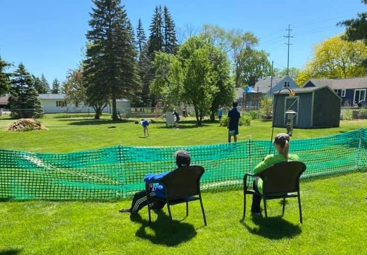 The game of Wiffle Ball lends itself naturally to social distancing. Families who came to watch were able to sit 6 feet away from those in other households.  