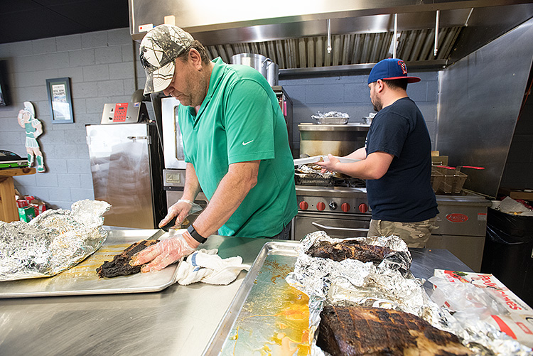 Craig “Gump” Garmyn cuts brisket at Gump's BBQ-Photo Dave Trumpie