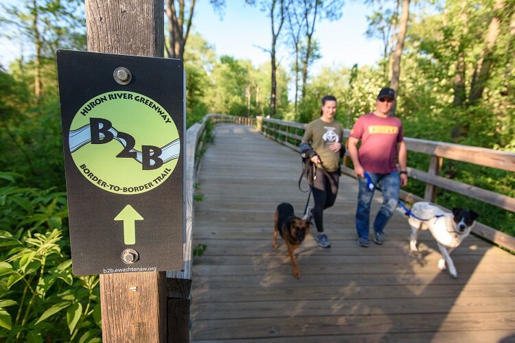 Dogwalkers enjoy a stroll on a section of the B2B Trail in Dexter.
