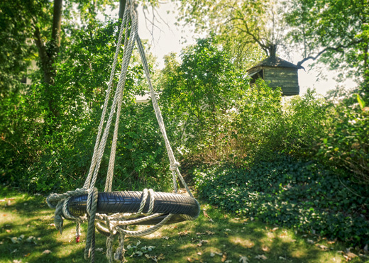 A tire swing and tree house on Oak Street