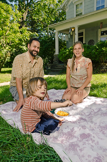 Rachel and Tarek Kanaan with their son River outside their Oak Street home