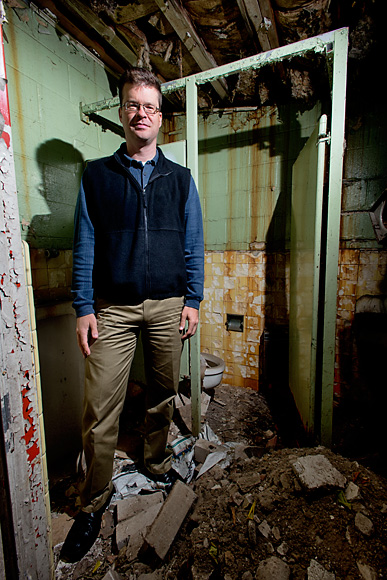 Nathan Voght inside the abandoned gas station at 544 Detroit Street