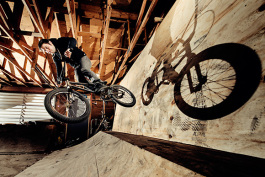 Thomas Hosford riding an Ordnance BMX Bike at an indoor BMX half pipe