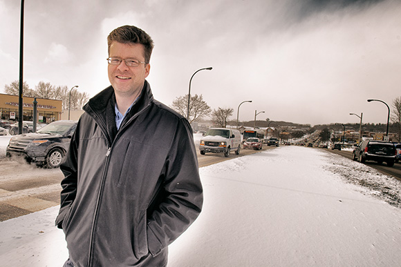 Nathan Voght of ReImagine Washtenaw in the middle of Washtenaw Avenue near Arborland