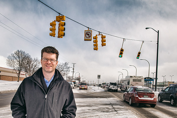 Nathan Voght of ReImagine Washtenaw in the middle of Washtenaw Avenue near Arborland