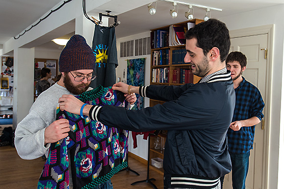 Checking out a Cosby sweater at the A2Share Clothing Swap at Canterbury House