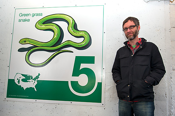 Bruce Worden with one of his art panels at the Maynard Parking Structure in Ann Arbor