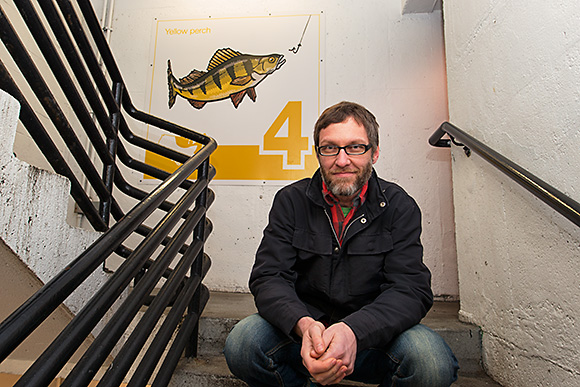 Bruce Worden with one of his art panels at the Maynard Parking Structure in Ann Arbor