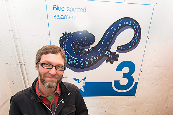 Bruce Worden with one of his art panels at the Maynard Parking Structure in Ann Arbor
