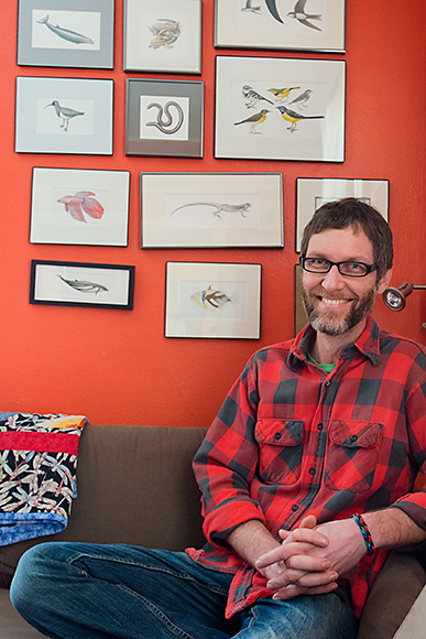 Bruce Worden at home with some of his illustrations