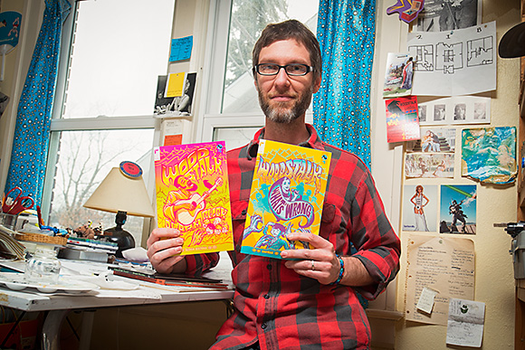 Bruce Worden with his Woodstalk comic books 